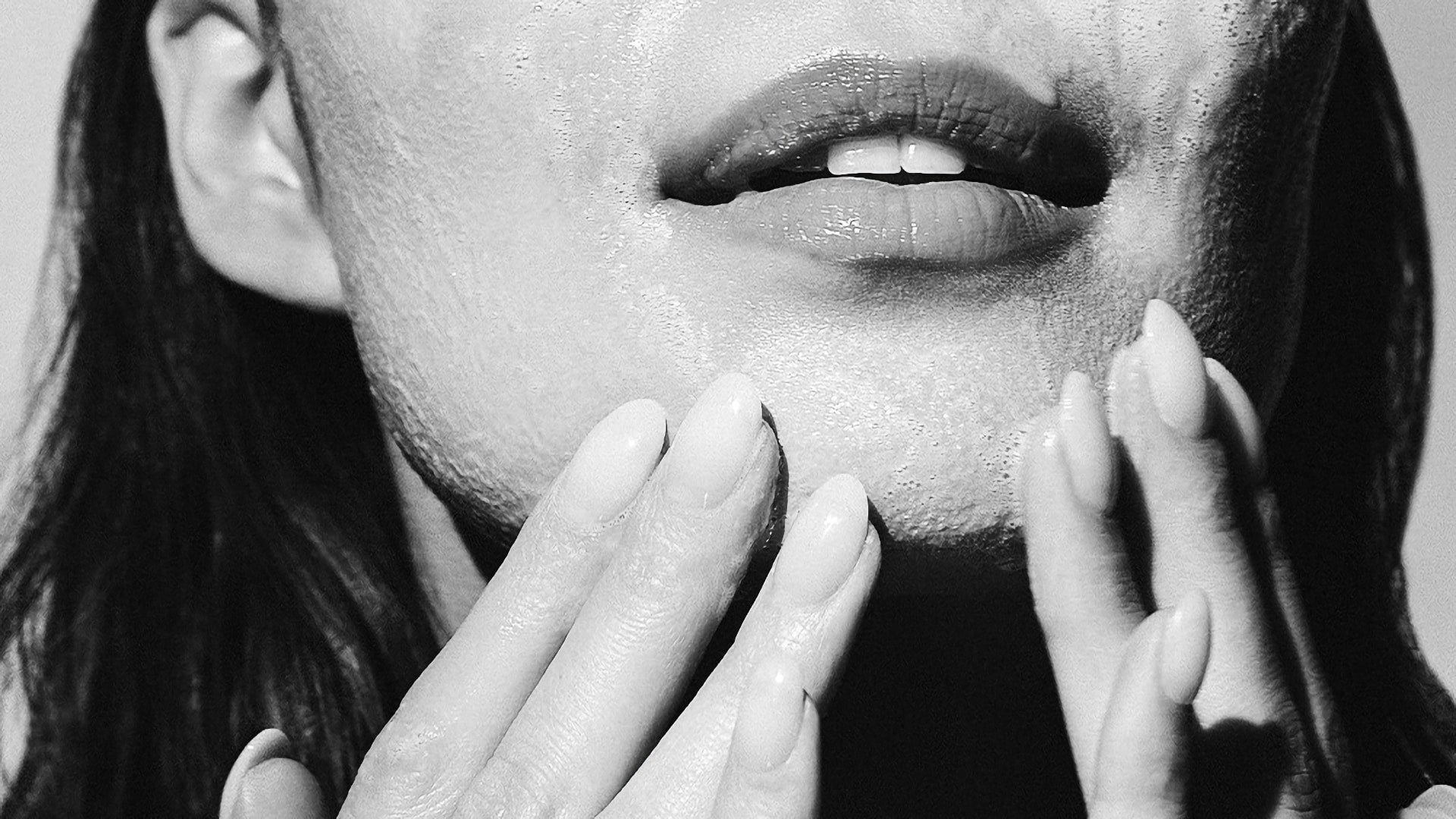 Close-up of a person's face with hands washing face around the mouth and chin