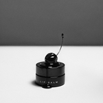 LBH Skincare Lip Balm - Black lip balm container with a cherry on top against a gray background