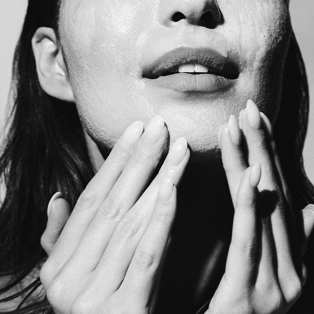 Model cleansing face with LBH Skincare AHA Cleanser