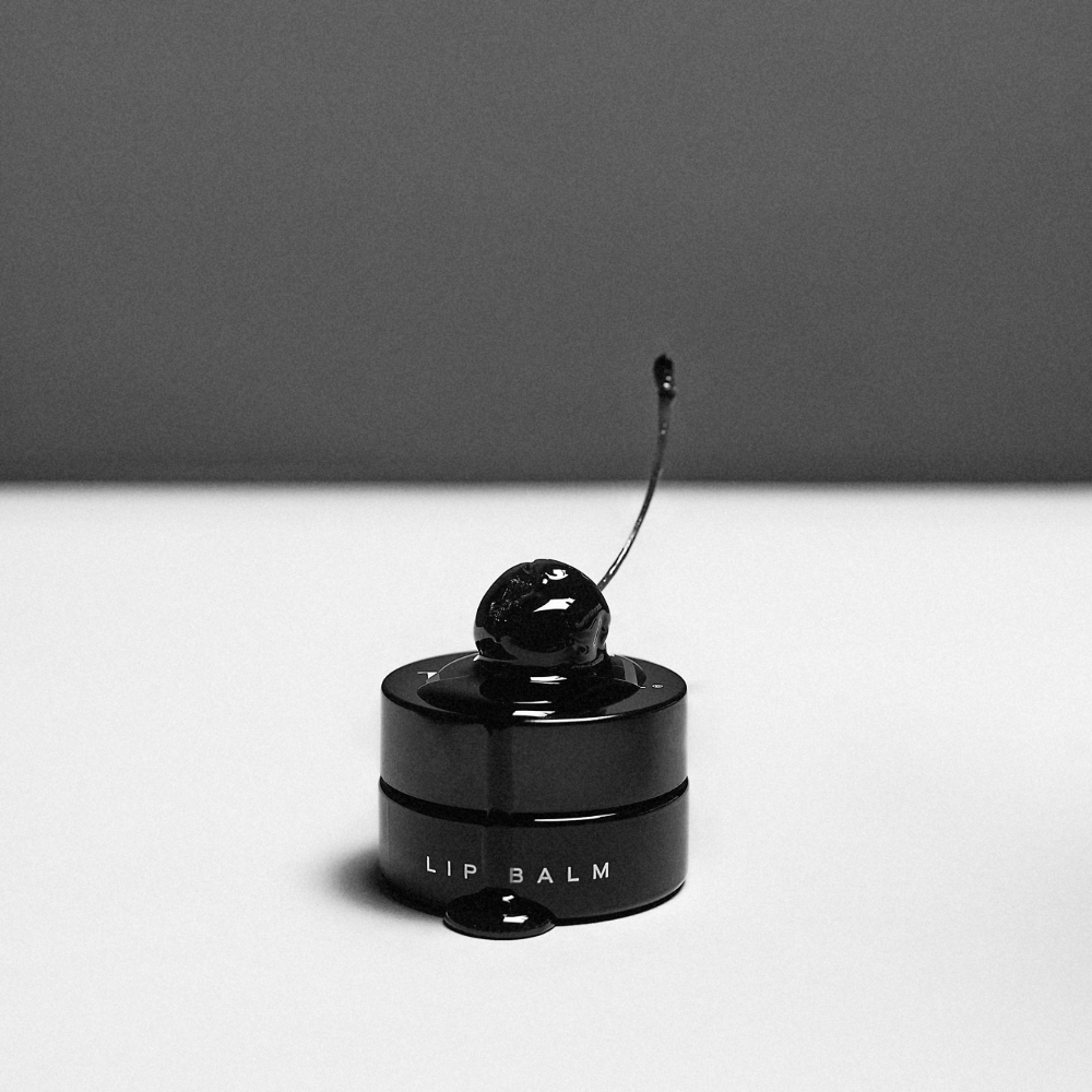 LBH Skincare Lip Balm black jar with cherry editorial styling